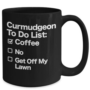 May include: Black coffee mug with white text that reads "Curmudgeon To Do List:" with a checkmark next to "Coffee" and empty boxes next to "No" and "Get Off My Lawn".