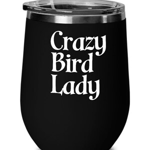 May include: Black stainless steel wine tumbler with a white inscription that reads "Crazy Bird Lady".
