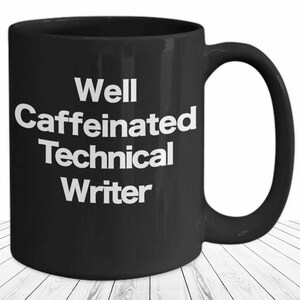 May include: Black coffee mug with white text that reads "Well Caffeinated Technical Writer".