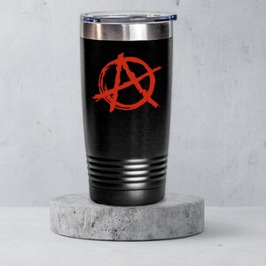 May include: A black stainless steel tumbler with a red anarchy symbol on the front.