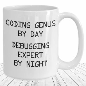May include: White ceramic coffee mug with black text that reads "Coding Genius by Day Debugging Expert by Night".