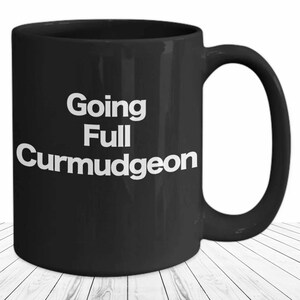 May include: Black coffee mug with white text that reads "Going Full Curmudgeon".