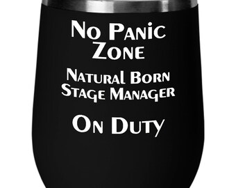 May include: Black stainless steel wine tumbler with white text that reads "No Panic Zone Natural Born Stage Manager On Duty".