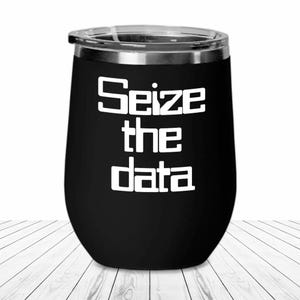 May include: Black stainless steel wine tumbler with white text that reads "Seize the data".