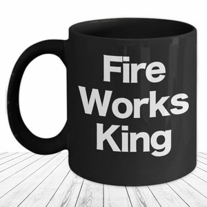 May include: Black ceramic coffee mug with white text that reads "Fire Works King".