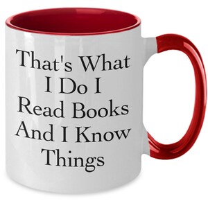 May include: White ceramic coffee mug with a red rim and handle. The mug has black text that reads "That's What I Do I Read Books And I Know Things."