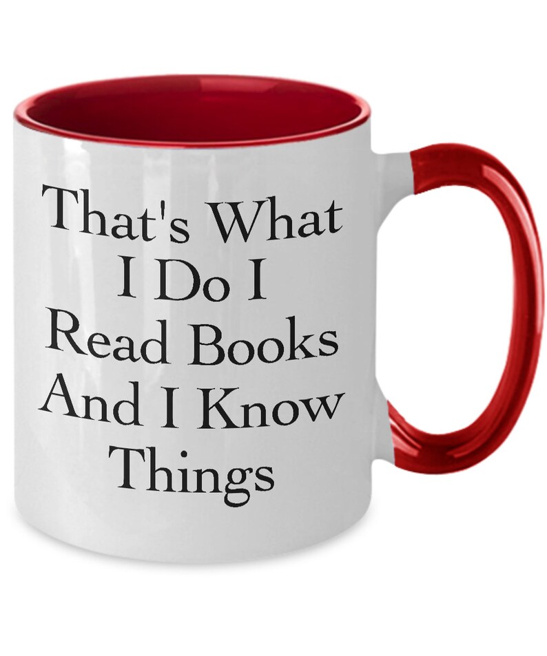 May include: White ceramic coffee mug with a red rim and handle. The mug has black text that reads "That's What I Do I Read Books And I Know Things."