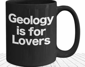 May include: Black coffee mug with white text that reads "Geology is for Lovers".