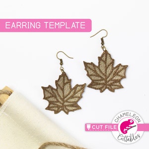 May include: A pair of maple leaf earrings with a textured, metallic gold finish. The earrings are suspended from bronze-colored hooks. The image includes the text "EARRING TEMPLATE" and a logo with the text "Chameleon Cuttables".