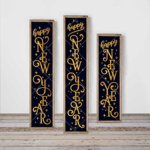 May include: Three wooden signs with a dark blue background and gold glitter lettering that reads "happy new year".