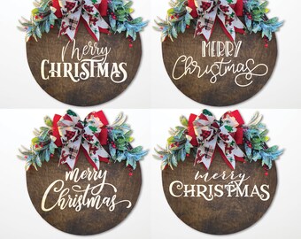 May include: Four wooden Christmas signs with the words "Merry Christmas" in white script. Each sign is a dark brown circle, decorated with a red and plaid bow, greenery, and red berries. A festive holiday decoration.