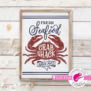 May include: A white sign with blue and red lettering that reads "Fresh Seafood Crab Shack since 1912". The sign features a red crab illustration.