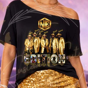 May include: Black t-shirt featuring a gold graphic of the music group New Edition. The graphic includes the group's name, members' names, and album titles. The shirt is paired with gold sequin shorts.