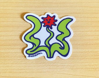 May include: A green and blue sticker with a red flower with a face. The flower has a white background and the sticker has the text "@NAHCROLL" at the bottom.