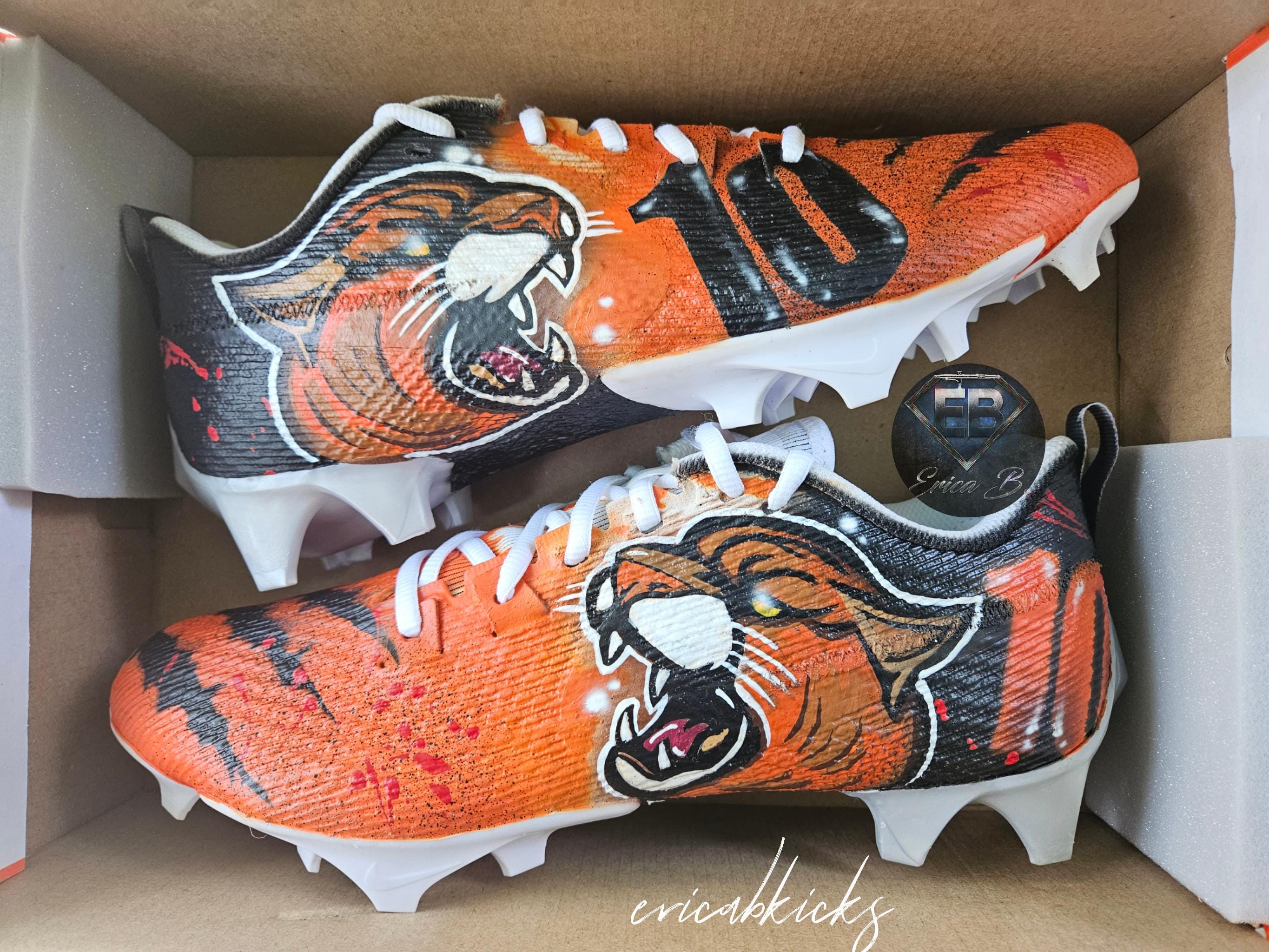 orange and black football cleats