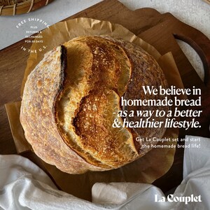 May include: A freshly baked loaf of sourdough bread on a wooden cutting board. The bread has a golden-brown crust with visible scoring. Text on the image reads, "We believe in homemade bread - as a way to a better & healthier lifestyle."