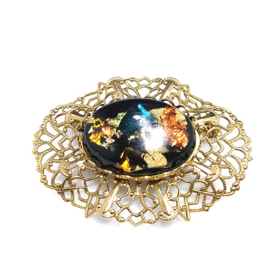 Black and gold brooch discount
