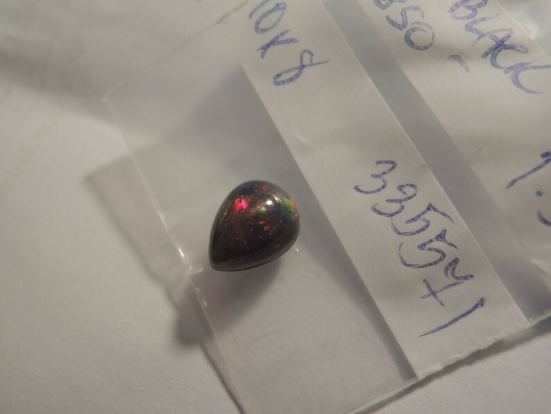 1.58ct solid Black Natural Opal 10 x 8 mm approximate never set Multi color sparks or color