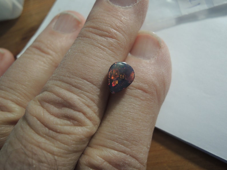 1.58ct solid Black Natural Opal 10 x 8 mm approximate never set Multi color sparks or color