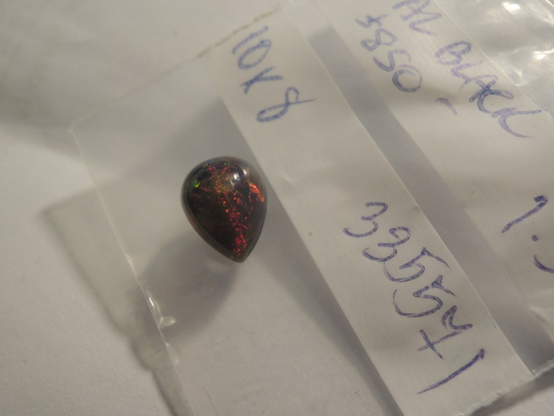 1.58ct solid Black Natural Opal 10 x 8 mm approximate never set Multi color sparks or color