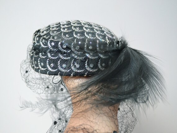 Black embroidered shinny pillbox hat, feather and