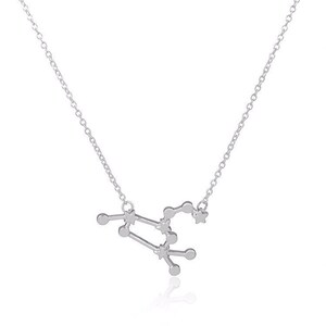 May include: A silver necklace with a delicate chain and a pendant shaped like the constellation Virgo. The pendant is made of small, interconnected circles and stars.
