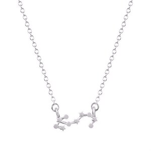 May include: A silver necklace with a delicate chain and a pendant shaped like the constellation Sagittarius.