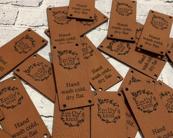 May include: A pile of brown leather labels with the text "Emily's Knits" and "Hand wash cold, dry flat" printed on them.