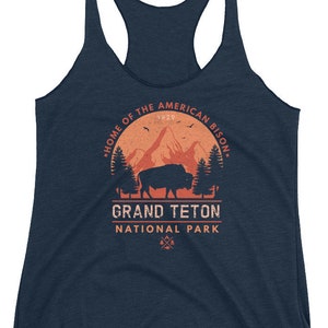 May include: A navy blue tank top with a vintage-style graphic of a bison in front of a mountain range. The graphic includes the text "Home of the American Bison", "Grand Teton", and "National Park".