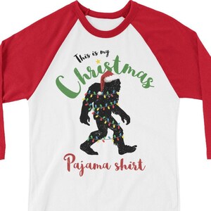 Bigfoot Christmas Pajama Shirt, Sasquatch Yeti Silhouette wearing Santa Hat, Wrapped in Holiday String Lights, 3/4 Sleeve Raglan Unisex Tee