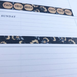 May include: A close-up of a planner with a floral patterned washi tape and the text "FUCK THIS WEEK" and "FUCK THIS SHIT" written on it.