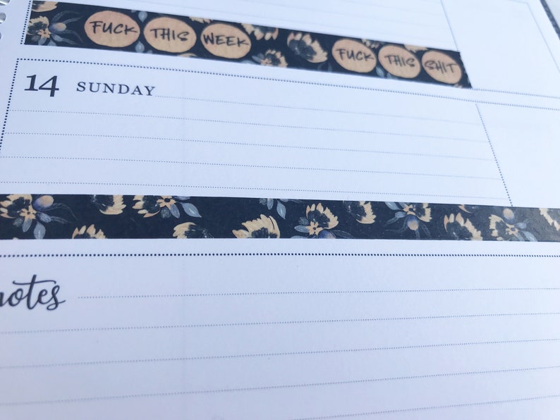 May include: A close-up of a planner with a floral patterned washi tape and the text "FUCK THIS WEEK" and "FUCK THIS SHIT" written on it.