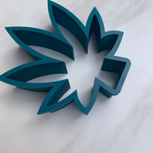 May include: A set of three ceramic nesting bowls in shades of blue, green, and white. The bowls feature a speckled glaze and a simple, modern design. The largest bowl is approximately 6 inches in diameter.