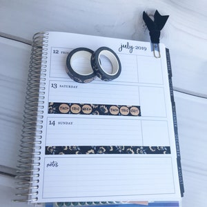 May include: A close-up of a July 2019 calendar page with a black and white floral patterned washi tape and a black washi tape with the text "FUCK THIS WEEK" and "FUCK THIS SHIT" on it.