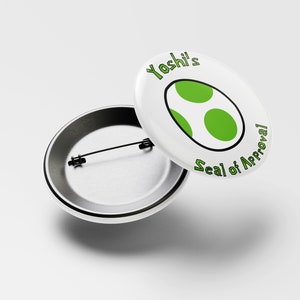 May include: White button with a green Yoshi egg and the text "Yoshi's Seal of Approval". The back of the button is silver.