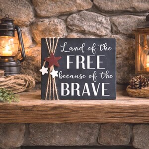 7 1/4" wood sign in navy blue styled on a rustic mantel with lanterns and greenery