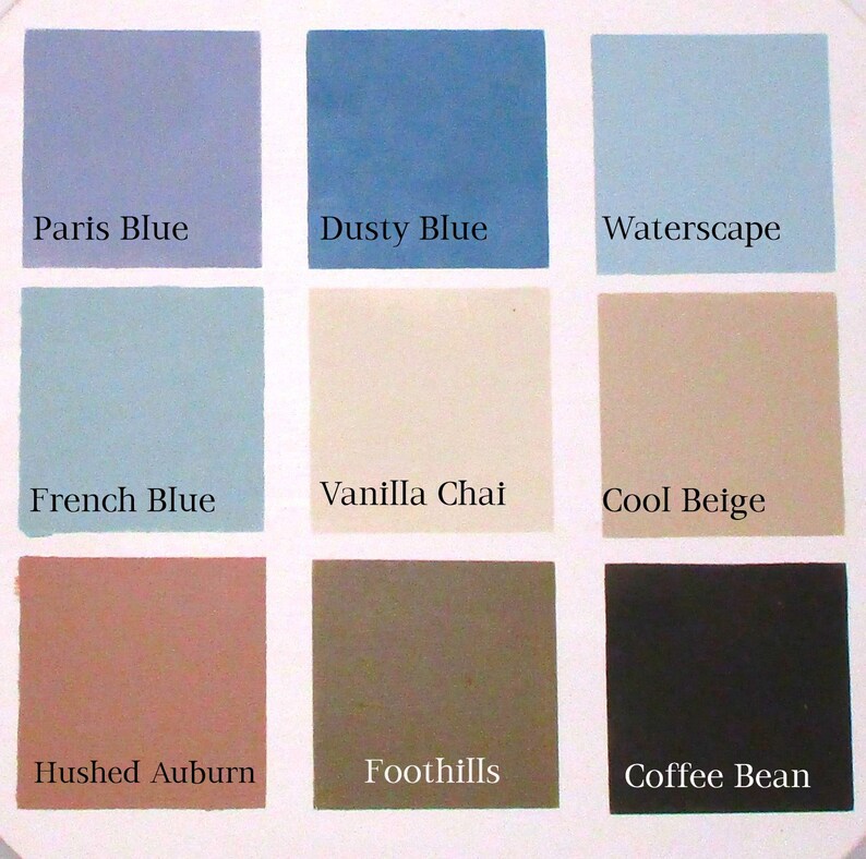 Nine paint color swatches with their names below each swatch. The swatches are arranged in three rows of three. The top row from left to right is Paris Blue, Dusty Blue, Waterscape. The middle row from left to right is French Blue, Vanilla Chai, Cool Beige. The bottom row from left to right is Hushed Auburn, Foothills, Coffee Bean.