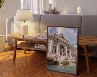 May include: A framed photograph of the Trevi Fountain in Rome, Italy. The fountain is a popular tourist destination and is known for its beautiful architecture and cascading water.