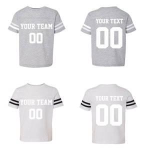 May include: Two gray and two white t-shirts with black and white striped sleeves. The shirts have a white number "00" and the text "YOUR TEAM" or "YOUR TEXT" printed on the front.