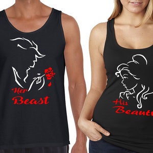 May include: A pair of black tank tops with a white silhouette of Belle and the Beast from Beauty and the Beast. The text "Her Beast" and "His Beauty" is in red on the shirts.