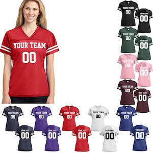 May include: A collection of customizable football jerseys in various colors, including red, black, green, pink, maroon, white, navy blue, and purple. Each jersey features the text "YOUR TEAM" and a number "00" on the front and back.