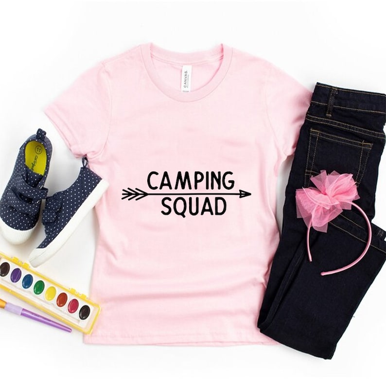 May include: Pink t-shirt with black text that reads "Camping Squad" with an arrow pointing to the right.