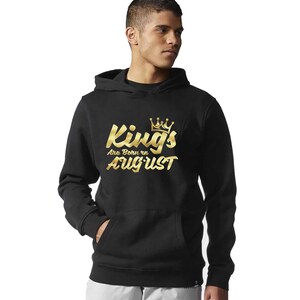 May include: Black hooded sweatshirt with a gold graphic that says "Kings Are Born in August" with a crown above the word "Kings".