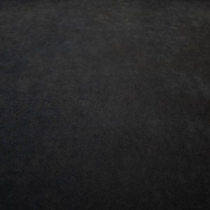 May include: A close-up of a dark gray textured surface.