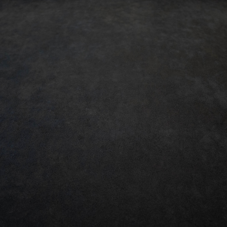 May include: A close-up of a dark gray textured surface.