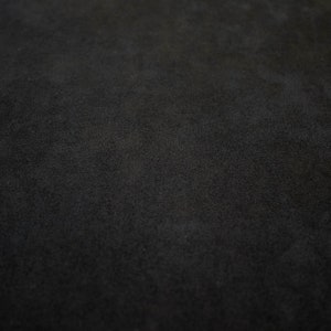 May include: A close-up of a black textured surface.