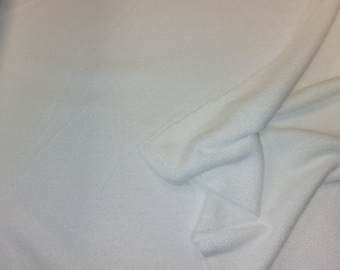 May include: White terry cloth fabric with a soft, textured surface. The fabric is folded in half, showing the inside and outside of the material.