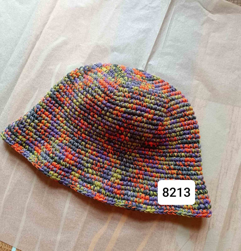 May include: A multi-colored crocheted bucket hat with a label that says "8213".