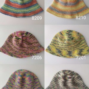 May include: Six crocheted bucket hats in various color combinations, including yellow, green, orange, pink, and blue. The hats are all made with a striped pattern.