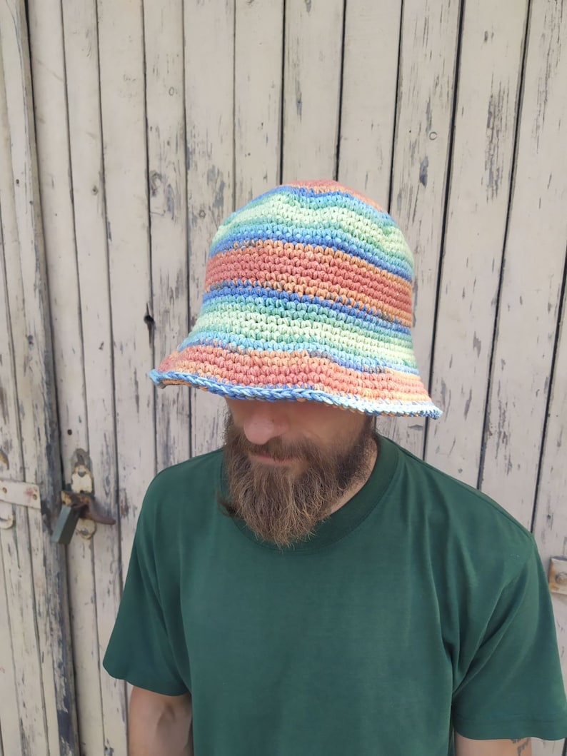 May include: A crocheted bucket hat with stripes of blue, green, pink, and orange.